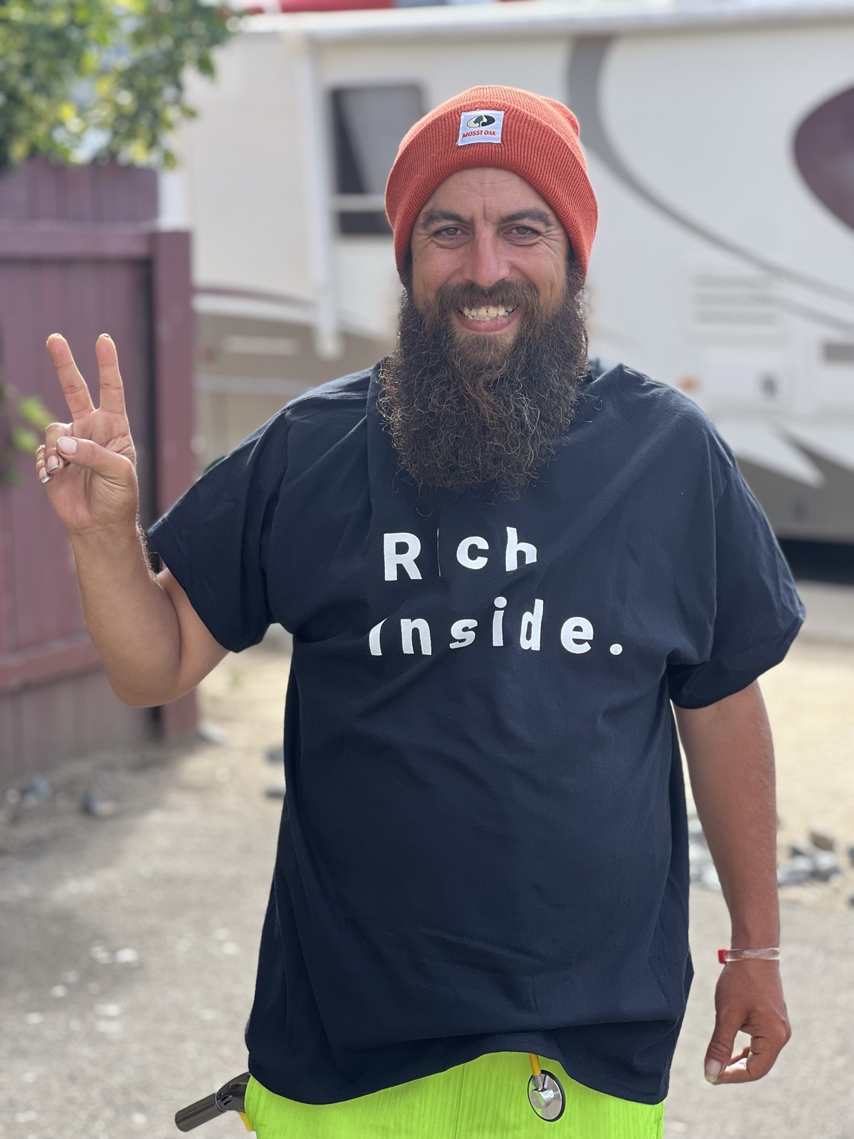 Man giving peace sign in Rich Inside tee