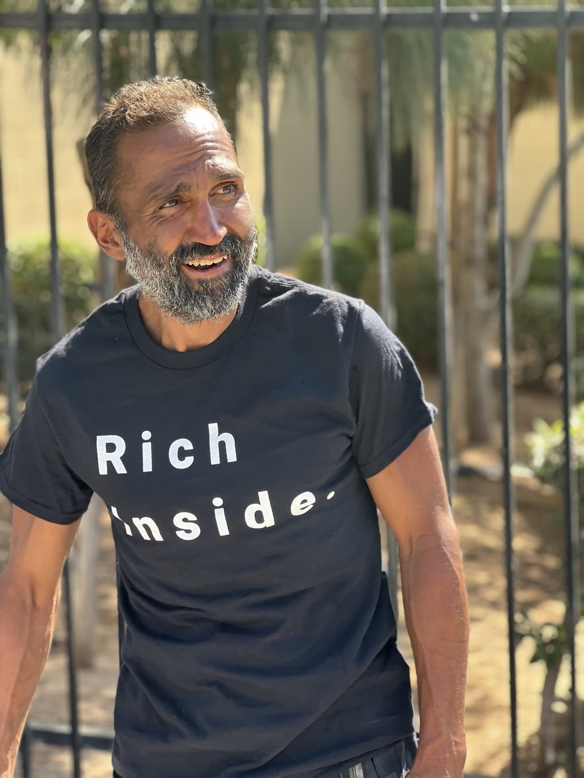 Man smiling wearing Rich Inside